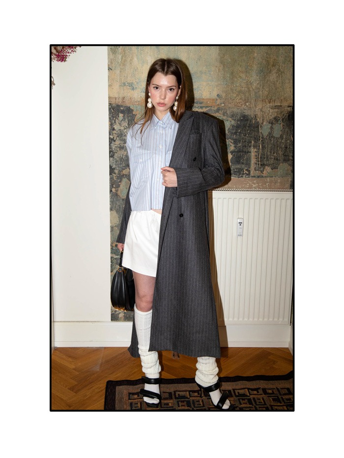 Second Hand Damenmantel in grau, kombiniert mit legeren Shorts und klassischer Hemdbluse – moderner Tailoring-Look für die neue Saison.